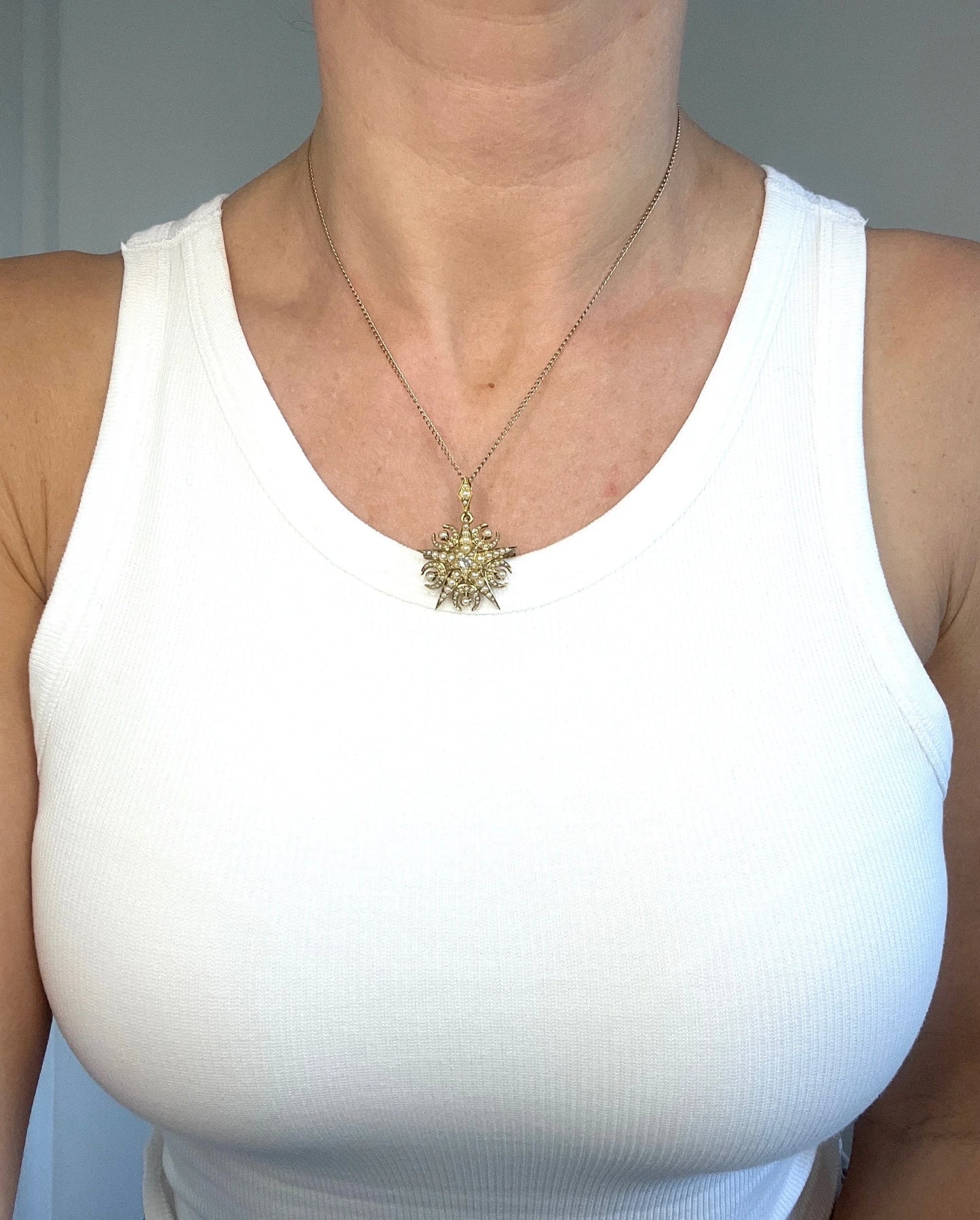 A yellow gold star and crescent brooch/pendant with pearls and a diamond centre, with a chain, modelled