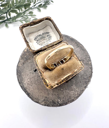A yellow gold ruby and diamond five stone ring, in a ring box