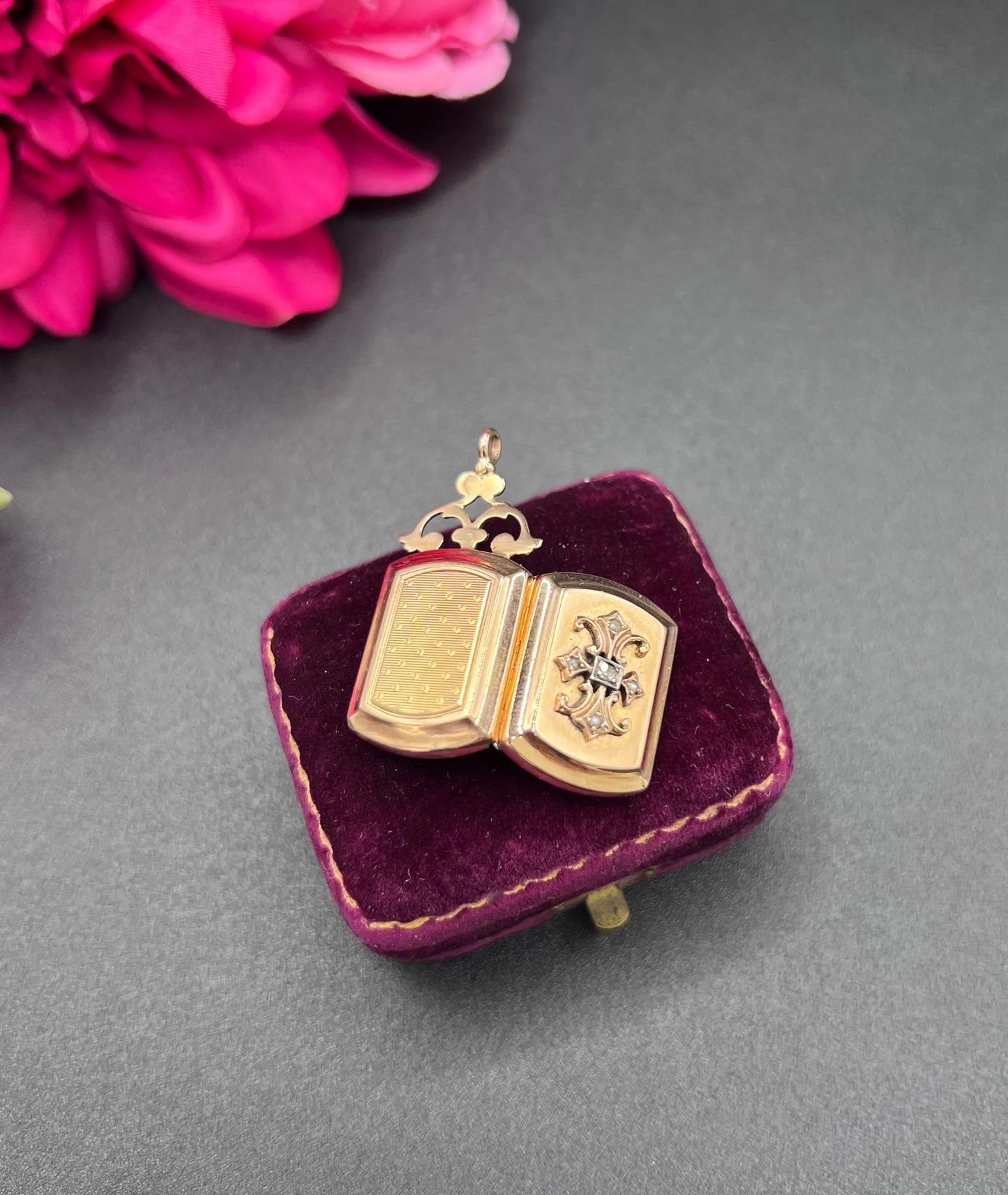 A yellow gold ornate locket with diamond fleur-de-lis detail, open