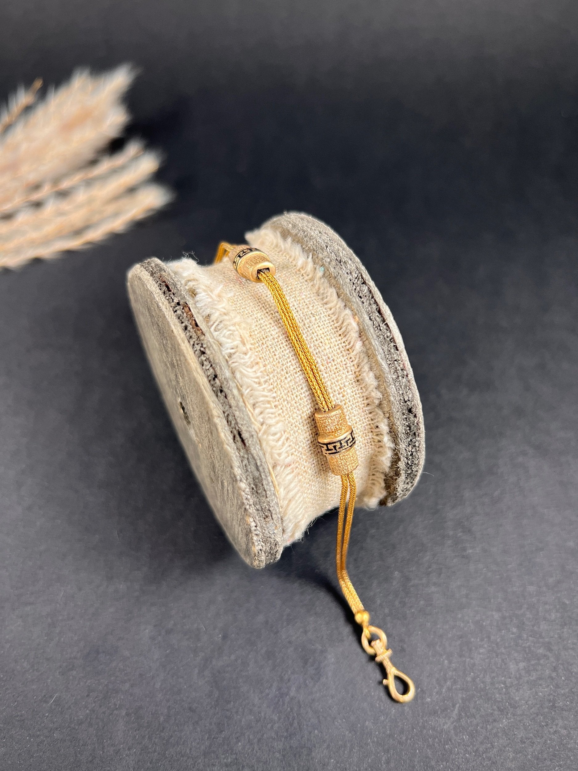 A yellow gold double row bracelet with black enamel tubular beads