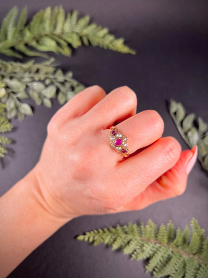 A yellow gold ruby and pearl floral cluster ring, modelled on a hand