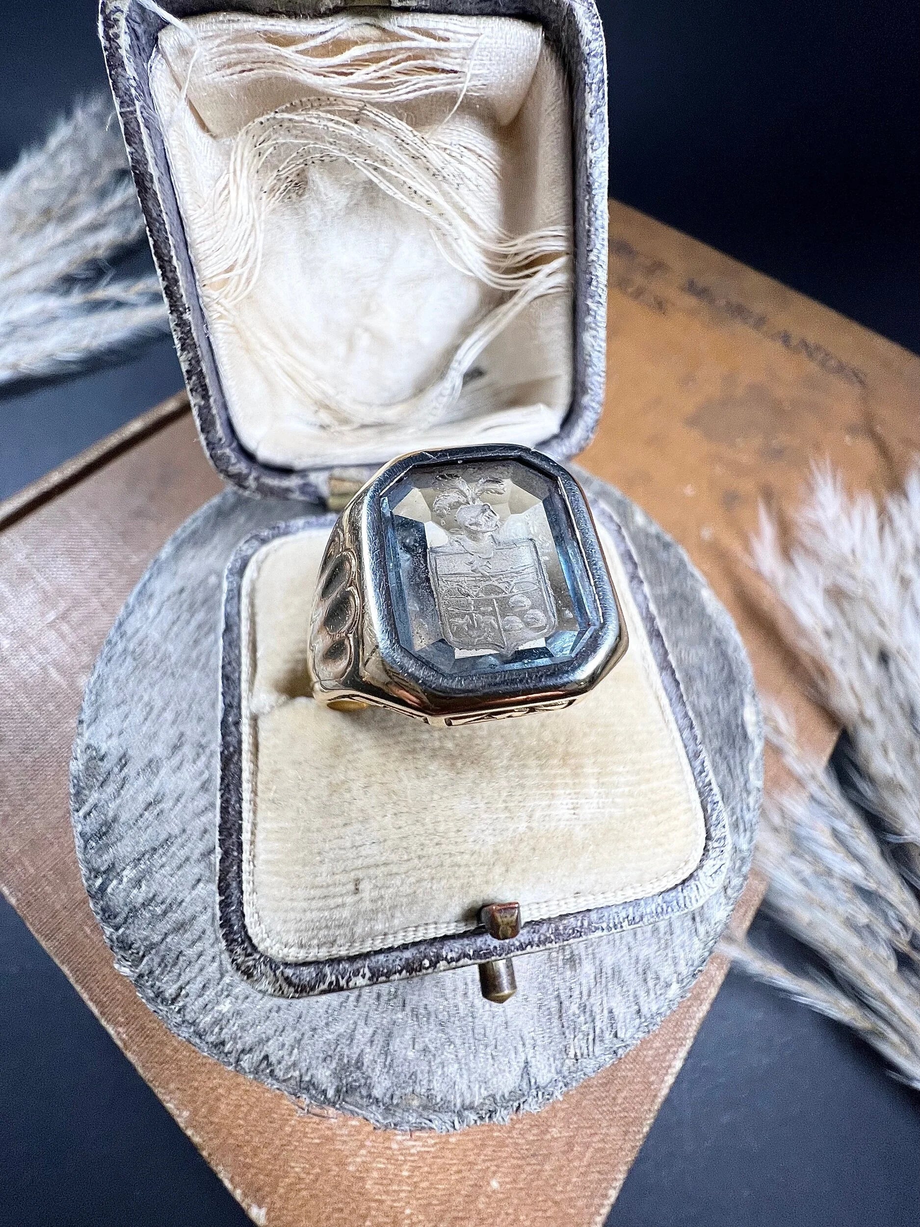 A yellow gold blue glass intaglio signet ring, in a ring box