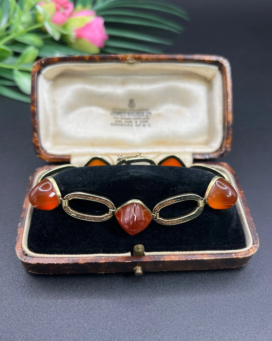 A cabochon carnelian, black enamel and yellow gold bracelet