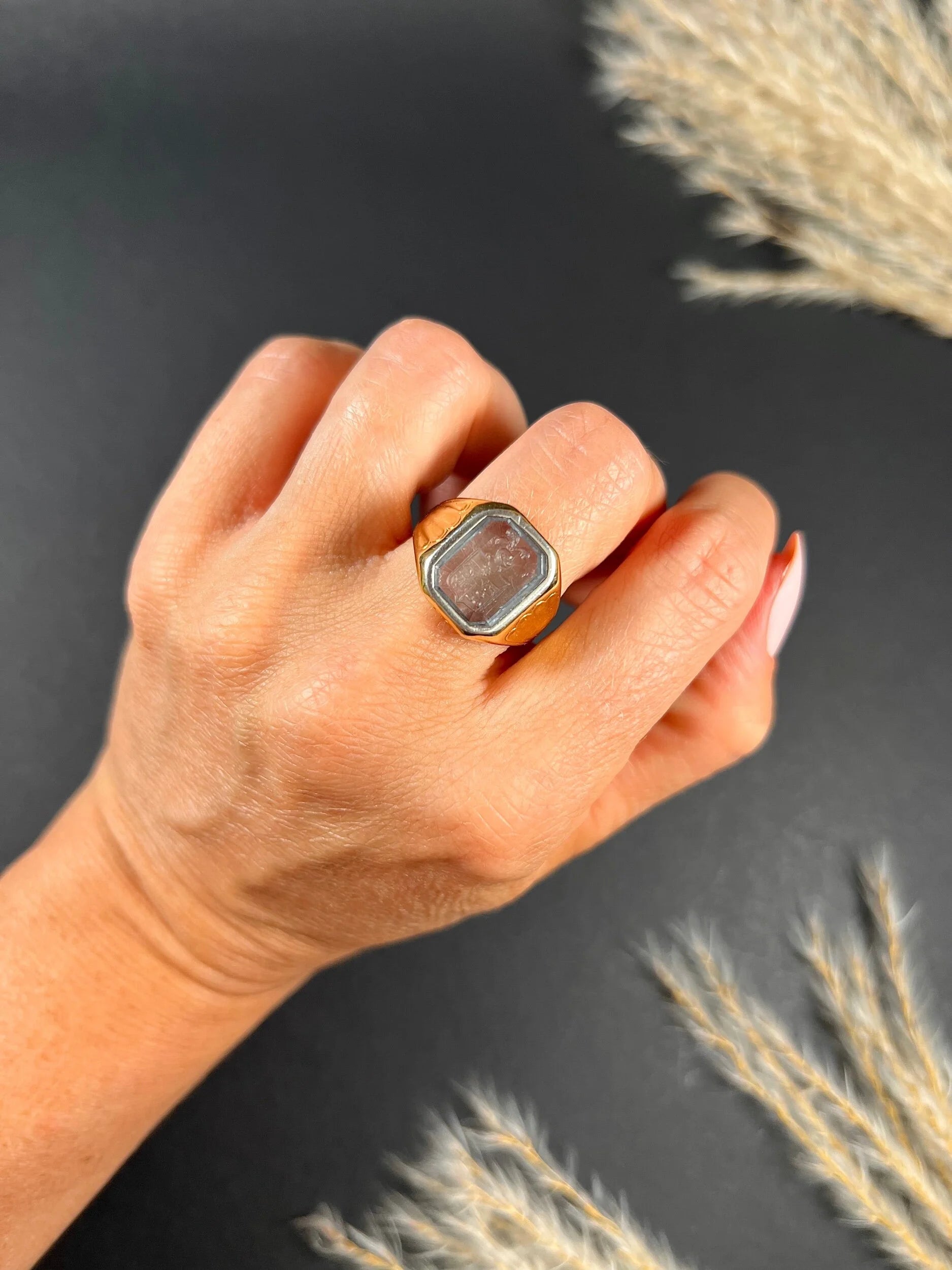 A yellow gold blue glass intaglio signet ring, modelled on a hand