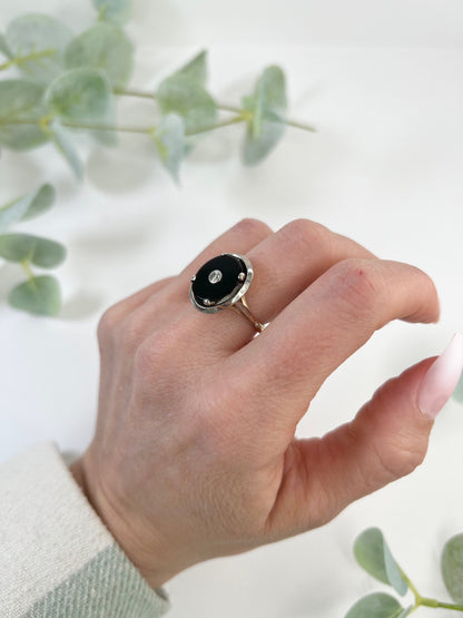Art Deco 18 Carat Two Colour Gold Oval Onyx and Diamond Halo Ring, Circa 1920