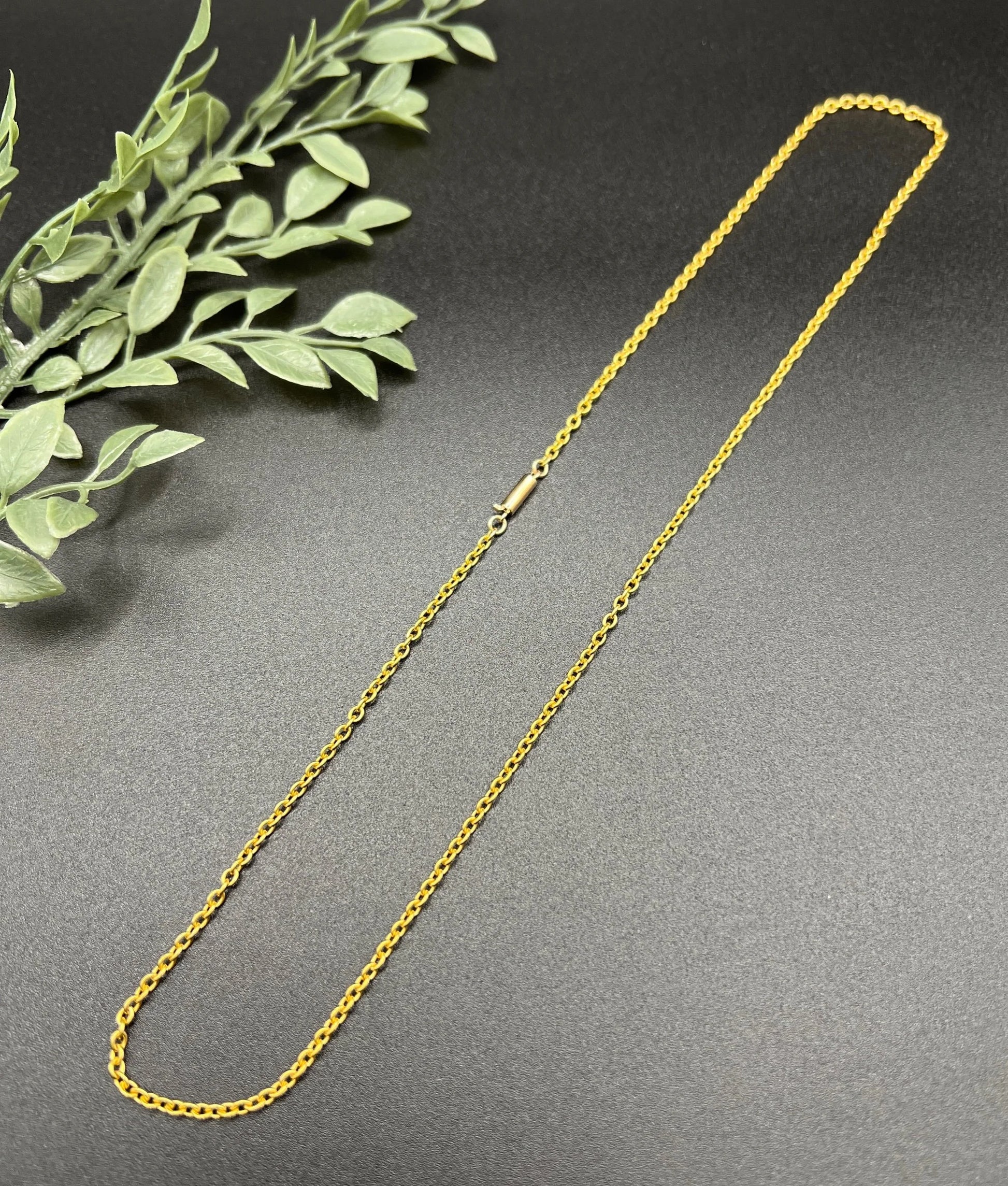 A yellow gold trace link chain necklace