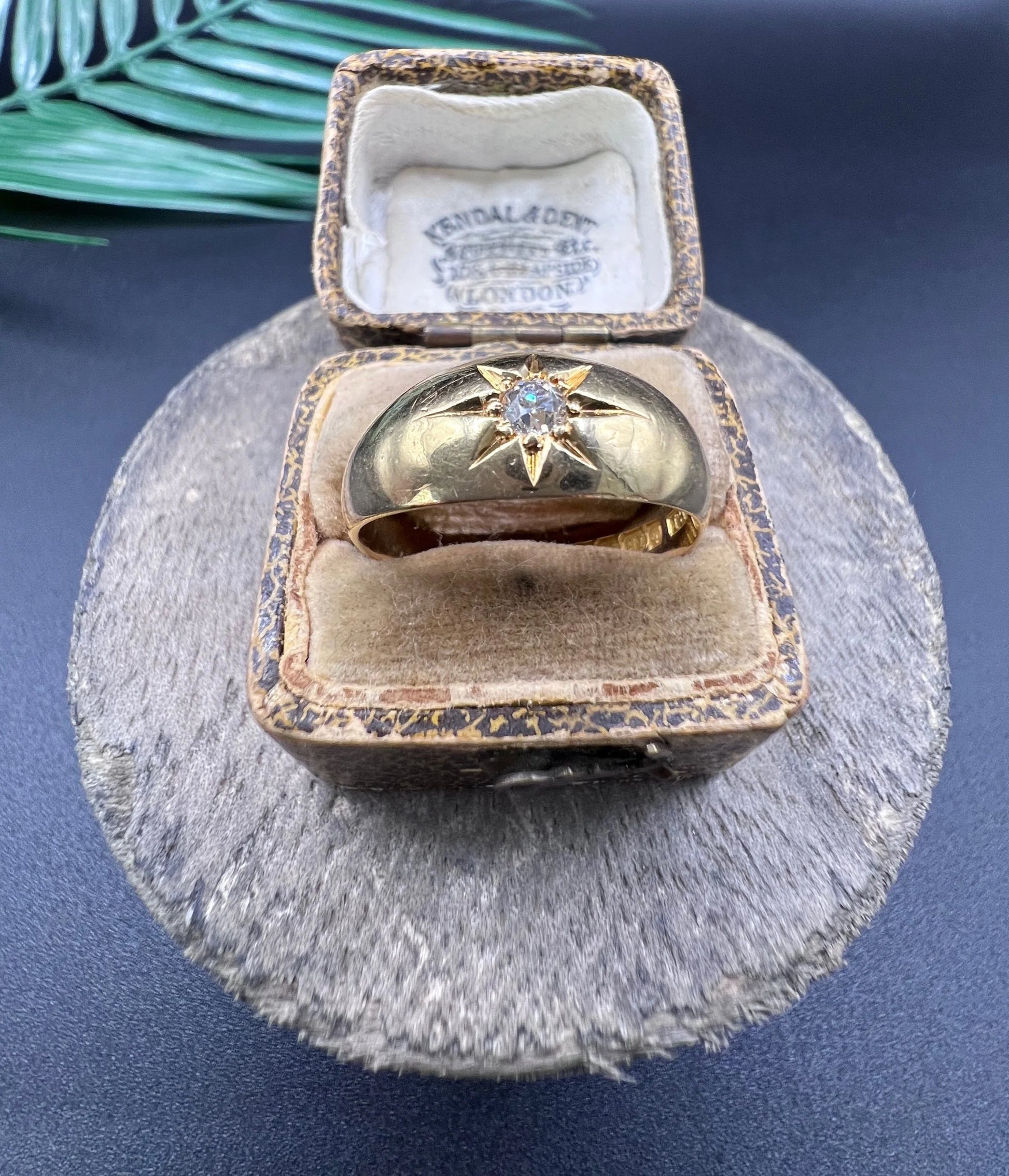 A single stone old cut diamond gypsy band ring in yellow gold, in an antique ring box