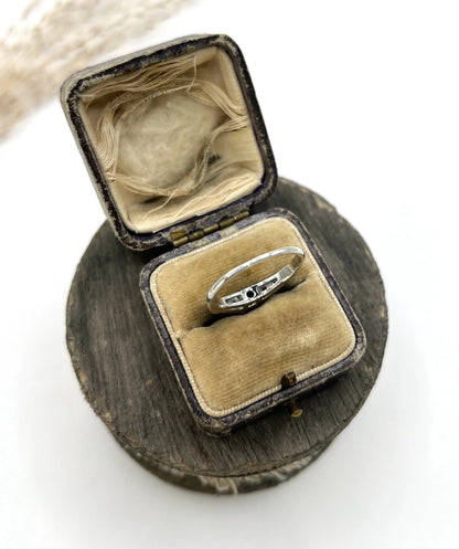 A solitaire diamond ring in platinum, with diamond set shoulders