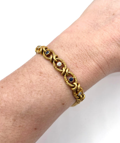 A sapphire and diamond fancy curb link bracelet in yellow gold, modelled on a wrist