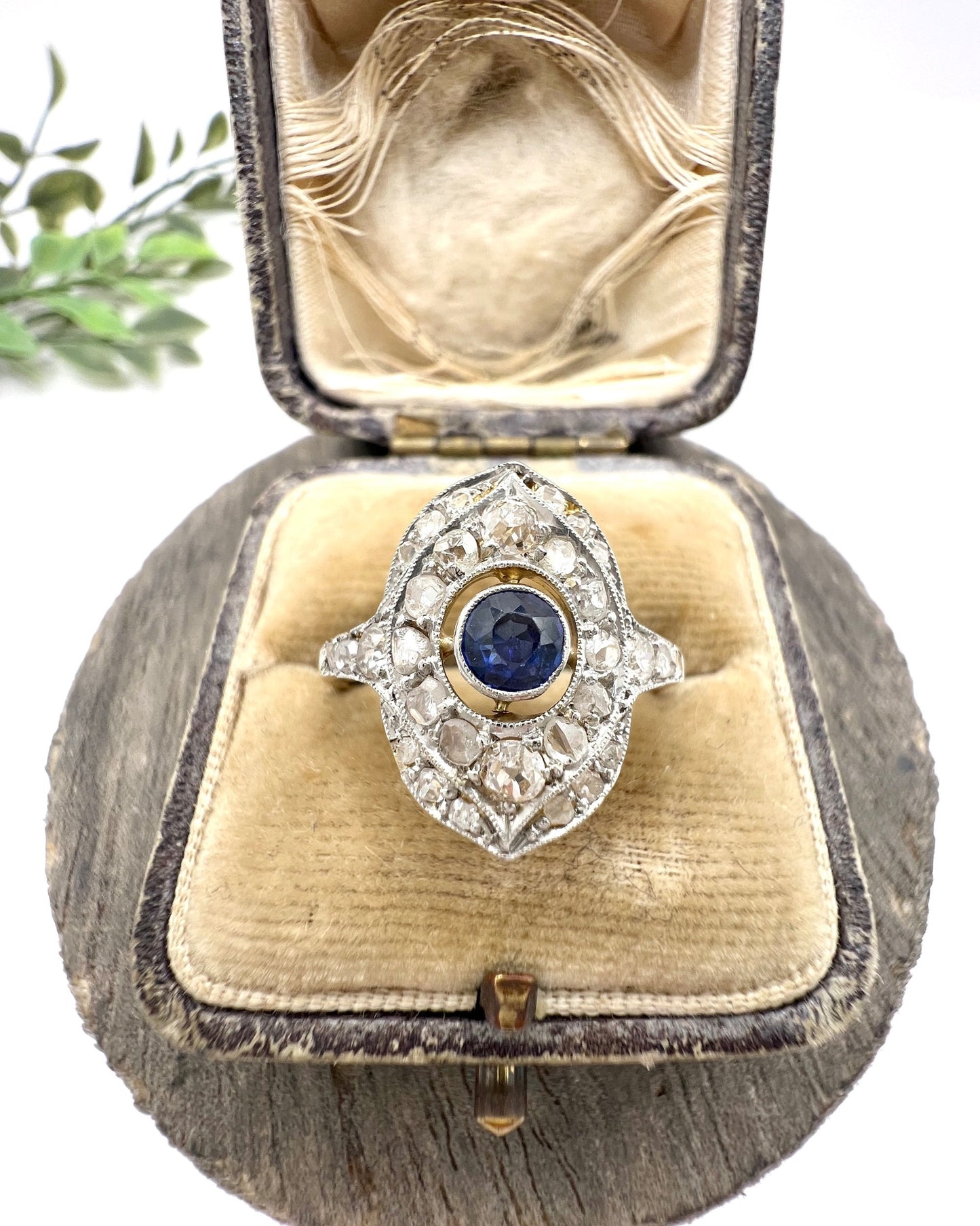 A sapphire and diamond openwork ring in platinum with a yellow gold ring shank, in an antique ring box