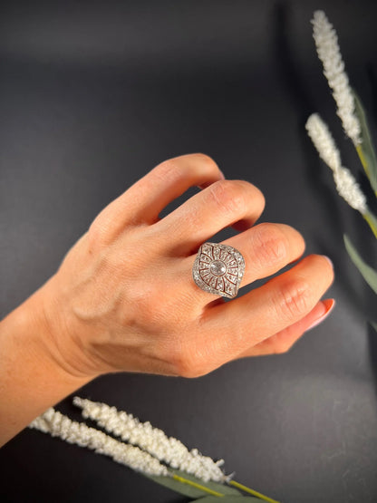A diamond cocktail ring in yellow and white metal modelled on a hand