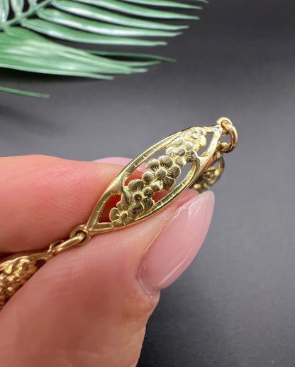 A yellow gold floral link bracelet