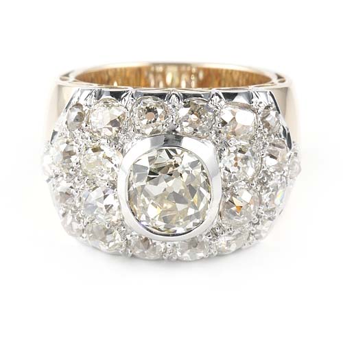 Art Deco 5.26ct Old Mine Cut Diamond Cluster Dress Ring, 2.06ct oval cushion-shaped old mine-cut diamond surrounded by 3.20 carats of chunky old-cut and rose-cut diamonds in an elegant twist of a bombe or tank design in platinum to 18ct yellow gold, Circa 1935
