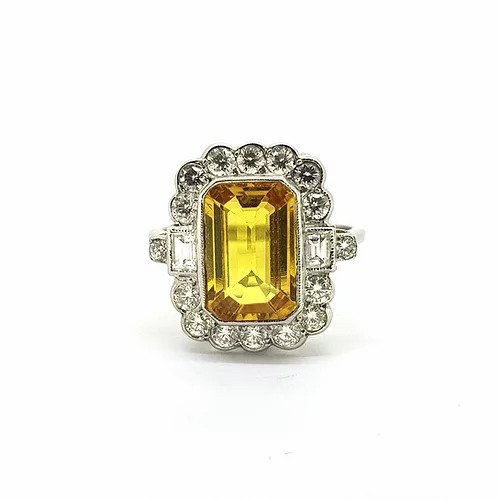 Emerald Cut Yellow Sapphire and Diamond Cluster Ring in Platinum; 4.00 carat emerald-cut yellow sapphire surrounded by 0.95cts brilliant and baguette-cut diamonds