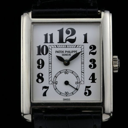 Patek Philippe 18ct White Gold Manual Winding Watch; 29mm 18ct white gold case with white porcelain dial and black Arabic hour markers, on an original Patek Philippe leather strap with an 18ct white gold Patek Philippe buckle, with certificate and Patek Philippe travel pouch