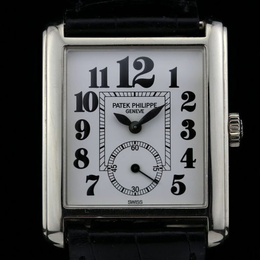 Patek Philippe 18ct White Gold Manual Winding Watch; 29mm 18ct white gold case with white porcelain dial and black Arabic hour markers, on an original Patek Philippe leather strap with an 18ct white gold Patek Philippe buckle, with certificate and Patek Philippe travel pouch