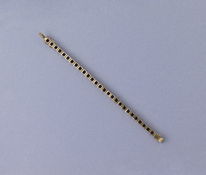 Modern Amethyst Line Bracelet; set with 29 round faceted deep purple amethysts. Mounted in 14ct yellow gold.