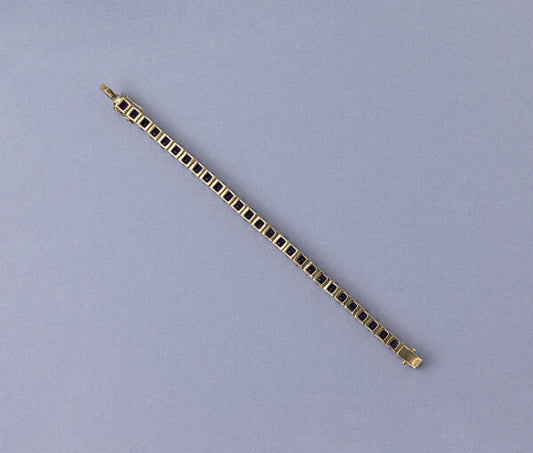 Modern Amethyst Line Bracelet; set with 29 round faceted deep purple amethysts. Mounted in 14ct yellow gold.