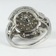 Vintage Diamond and Platinum Domed Cocktail Ring; central dome encrusted with brilliant diamonds, with a curve of tapered baguette diamonds and diamond set shoulders, 3.72 carat total. Numbered 995644