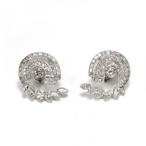 Vintage Diamond Earrings in Platinum; pair diamond scroll earrings, comprising a central round brilliant-cut diamond, surrounded by brilliant and single-cut diamonds, with an outer scroll of baguette and marquise-cut diamonds, 6.75 carat total, Circa 1950s