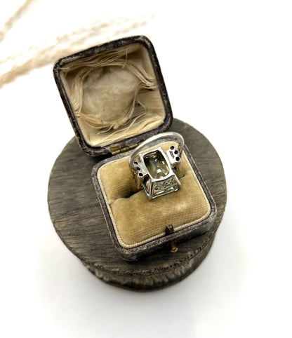 An aquamarine and diamond cocktail ring in white gold, in an antique ring box