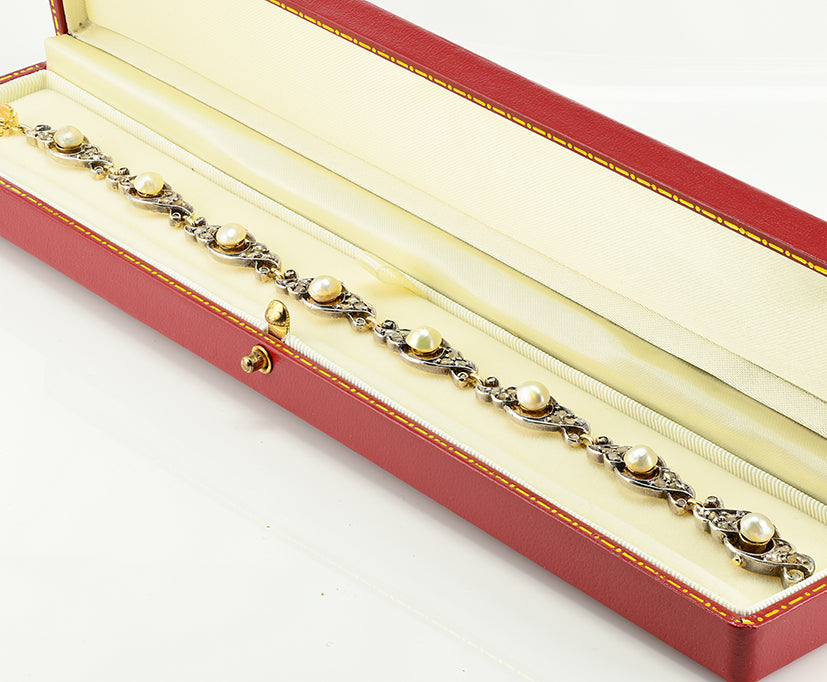 Edwardian Antique Natural Pearl and Rose Cut Diamond Bracelet, openwork scroll links set with rose-cut diamonds around natural pearls in silver upon 18ct yellow gold. Circa 1905