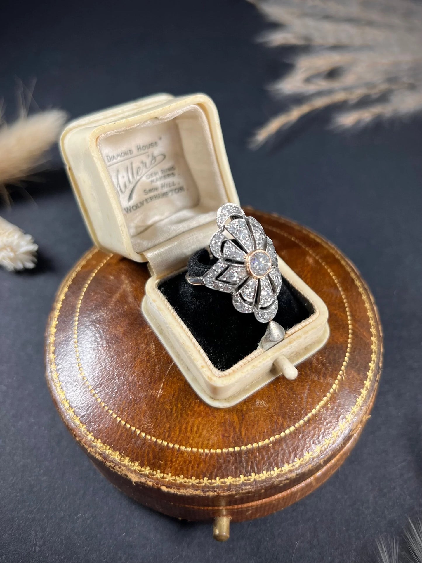 A diamond cocktail ring in white metal, in an antique ring box