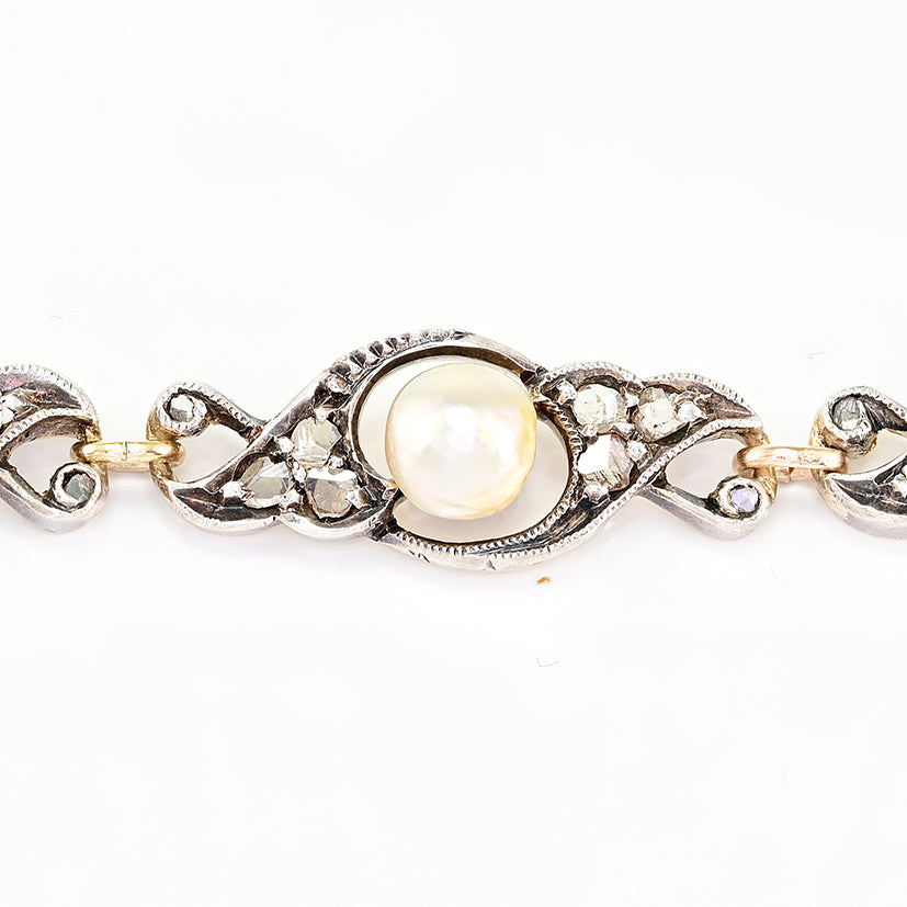 Edwardian Antique Natural Pearl and Rose Cut Diamond Bracelet, openwork scroll links set with rose-cut diamonds around natural pearls in silver upon 18ct yellow gold. Circa 1905