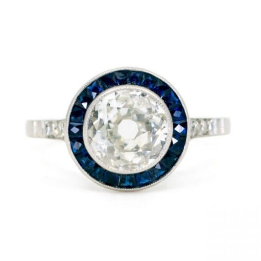 Art Deco Diamond and Sapphire Target Ring; central 1.23 carat old mine-cut diamond with calibre sapphire surround and single-cut diamond-set shoulders, in platinum