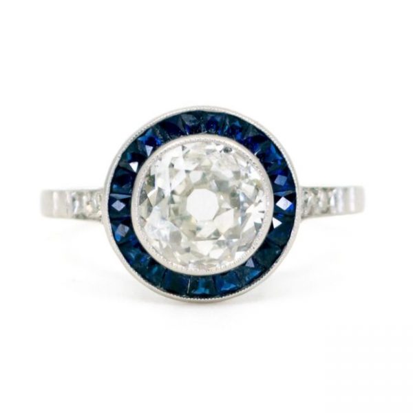 Art Deco Diamond and Sapphire Target Ring; central 1.23 carat old mine-cut diamond with calibre sapphire surround and single-cut diamond-set shoulders, in platinum