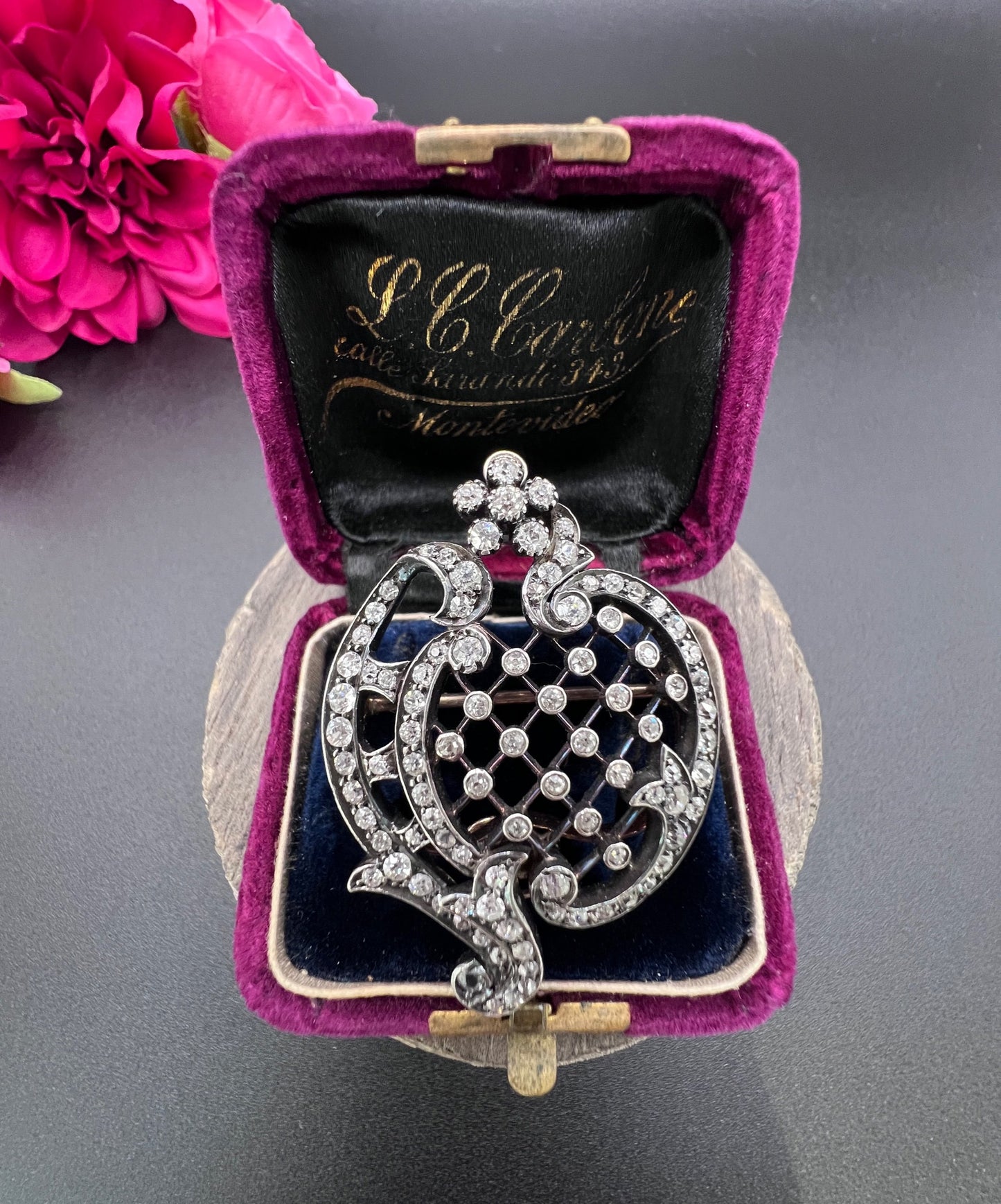 An openwork diamond set antique brooch in yellow gold and silver, in a box