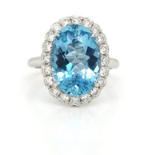 Aquamarine and Diamond Oval Cluster Ring; featuring a 5.33 carat oval faceted aquamarine surrounded by 0.68cts collet-set brilliant cut diamonds, mounted in platinum
