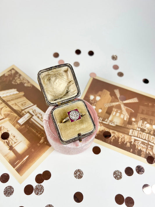 A square shaped ruby and diamond Art Deco style ring in yellow gold, in an antique ring box