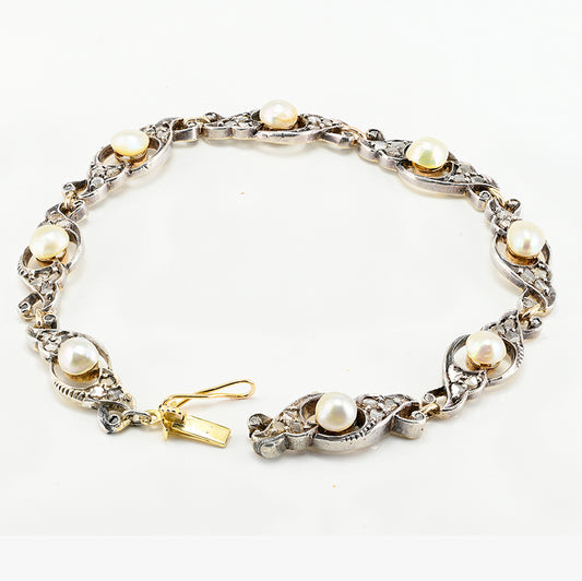 Edwardian Antique Natural Pearl and Rose Cut Diamond Bracelet, openwork scroll links set with rose-cut diamonds around natural pearls in silver upon 18ct yellow gold. Circa 1905