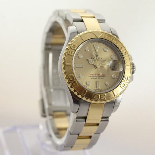 Rolex Yacht Master 169623 Ladies 29mm Steel and Gold Automatic Watch; champagne/gold colour dial with yellow gold rotating bezel, date indicator and sapphire crystal, on a steel and gold Oyster bracelet with steel and gold fold-over clasp, with Rolex box and papers