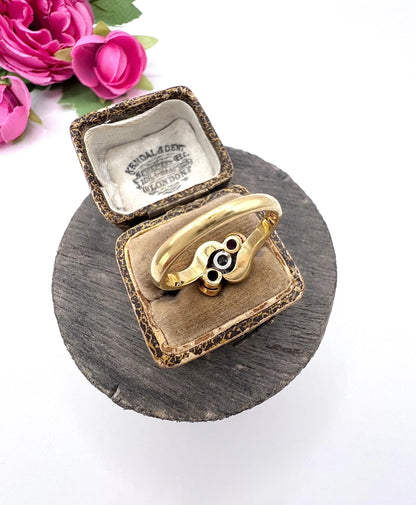 A three stone ruby and diamond crossover ring in platinum and yellow gold, in a ring box