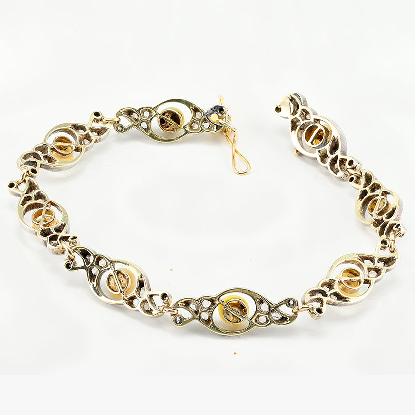 Edwardian Antique Natural Pearl and Rose Cut Diamond Bracelet, openwork scroll links set with rose-cut diamonds around natural pearls in silver upon 18ct yellow gold. Circa 1905