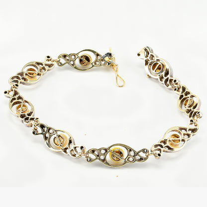 Edwardian Antique Natural Pearl and Rose Cut Diamond Bracelet, openwork scroll links set with rose-cut diamonds around natural pearls in silver upon 18ct yellow gold. Circa 1905