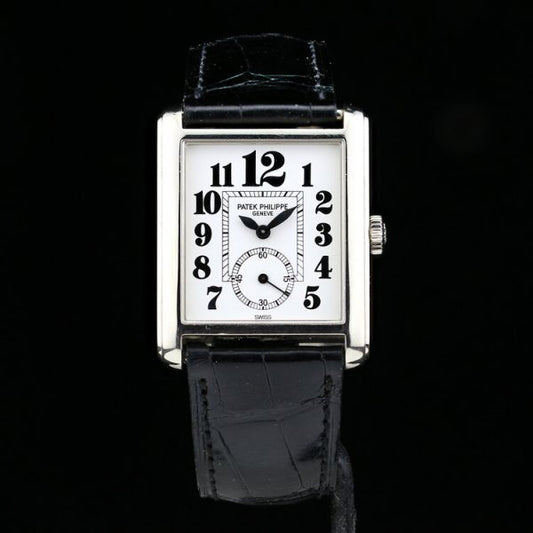 Patek Philippe 18ct White Gold Manual Winding Watch; 29mm 18ct white gold case with white porcelain dial and black Arabic hour markers, on an original Patek Philippe leather strap with an 18ct white gold Patek Philippe buckle, with certificate and Patek Philippe travel pouch