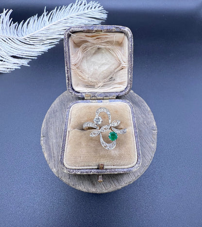 An emerald and diamond fancy openwork ring in yellow gold and platinum, in an antique ring box