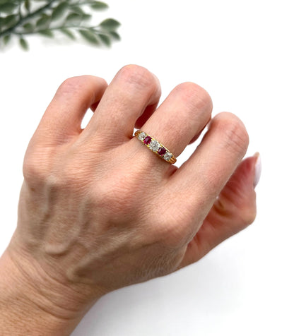A yellow gold ruby and diamond five stone ring, modelled on a hand