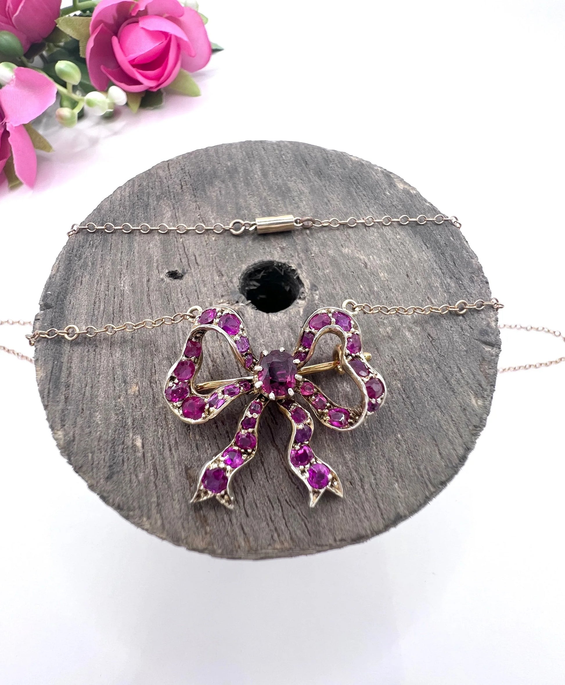 A ruby bow brooch necklace in gold and silver