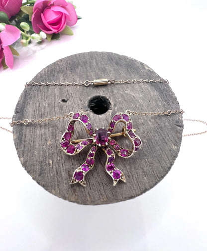 A ruby bow brooch necklace in gold and silver