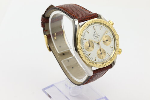 Omega Speedmaster Reduced 39mm Automatic Chronograph in Steel and Gold, white baton dial, yellow gold tachymetre bezel, on red/brown lizard strap with pin buckle.