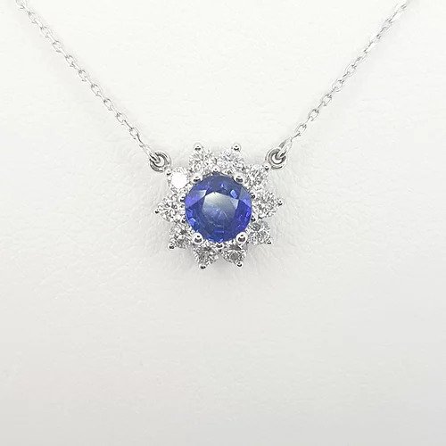 Sapphire and Diamond Cluster Pendant; featuring a round faceted sapphire surrounded by sparkling diamonds, in 18ct white gold