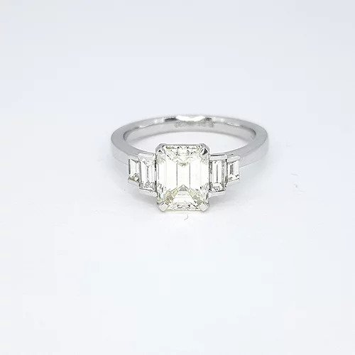 Emerald Cut Diamond and Platinum Engagement Ring; 1.54 carat emerald-cut diamond flanked by 0.43cts graduated baguette cut diamonds