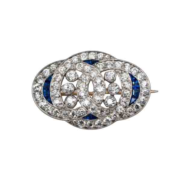 Art Deco Sapphire and Old Cut Diamond Brooch in Platinum; 4cts old European cut diamonds and 0.20cts natural sapphires, in platinum with intricate engraved edges, Circa 1920
