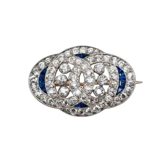 Art Deco Sapphire and Old Cut Diamond Brooch in Platinum; 4cts old European cut diamonds and 0.20cts natural sapphires, in platinum with intricate engraved edges, Circa 1920