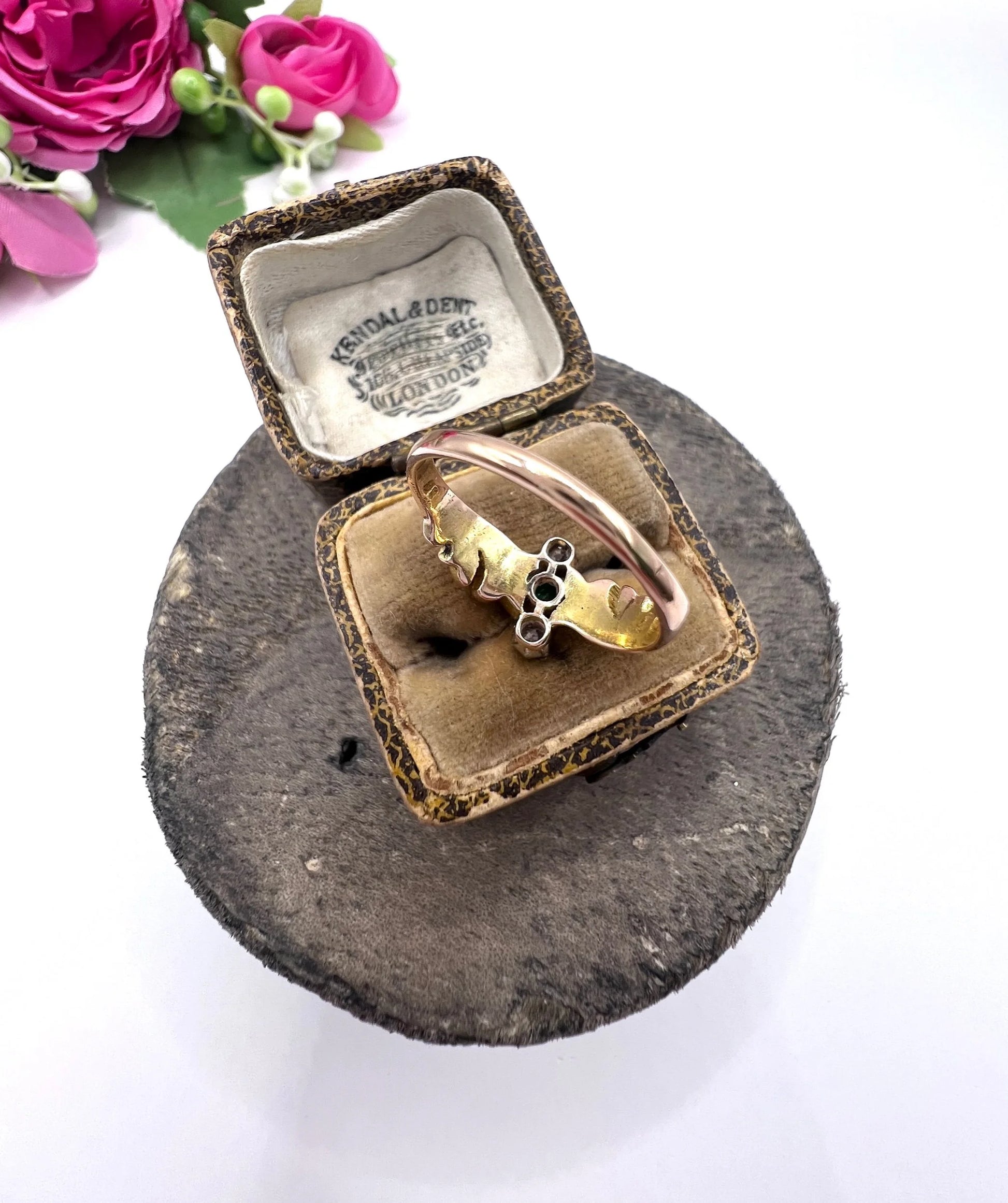 A three stone emerald and diamond ring in yellow and white gold