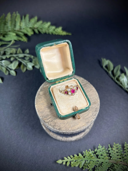 A yellow gold ruby and pearl floral cluster ring, in a ring box